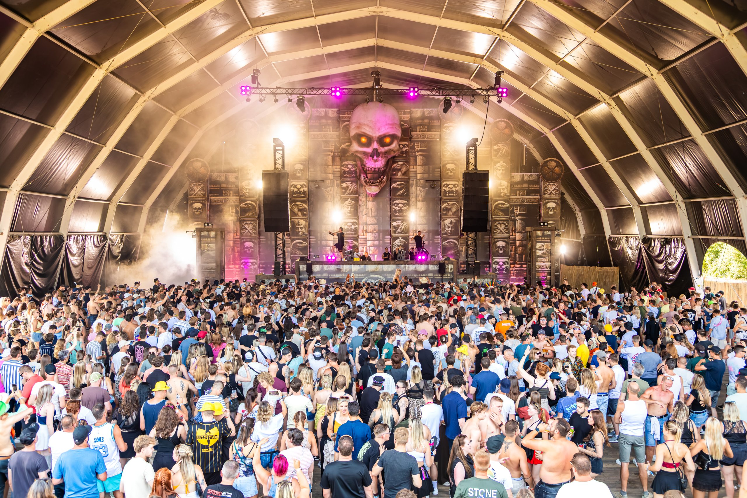 Crowd inside indoor hall with warm lighting at Magic Island Festival