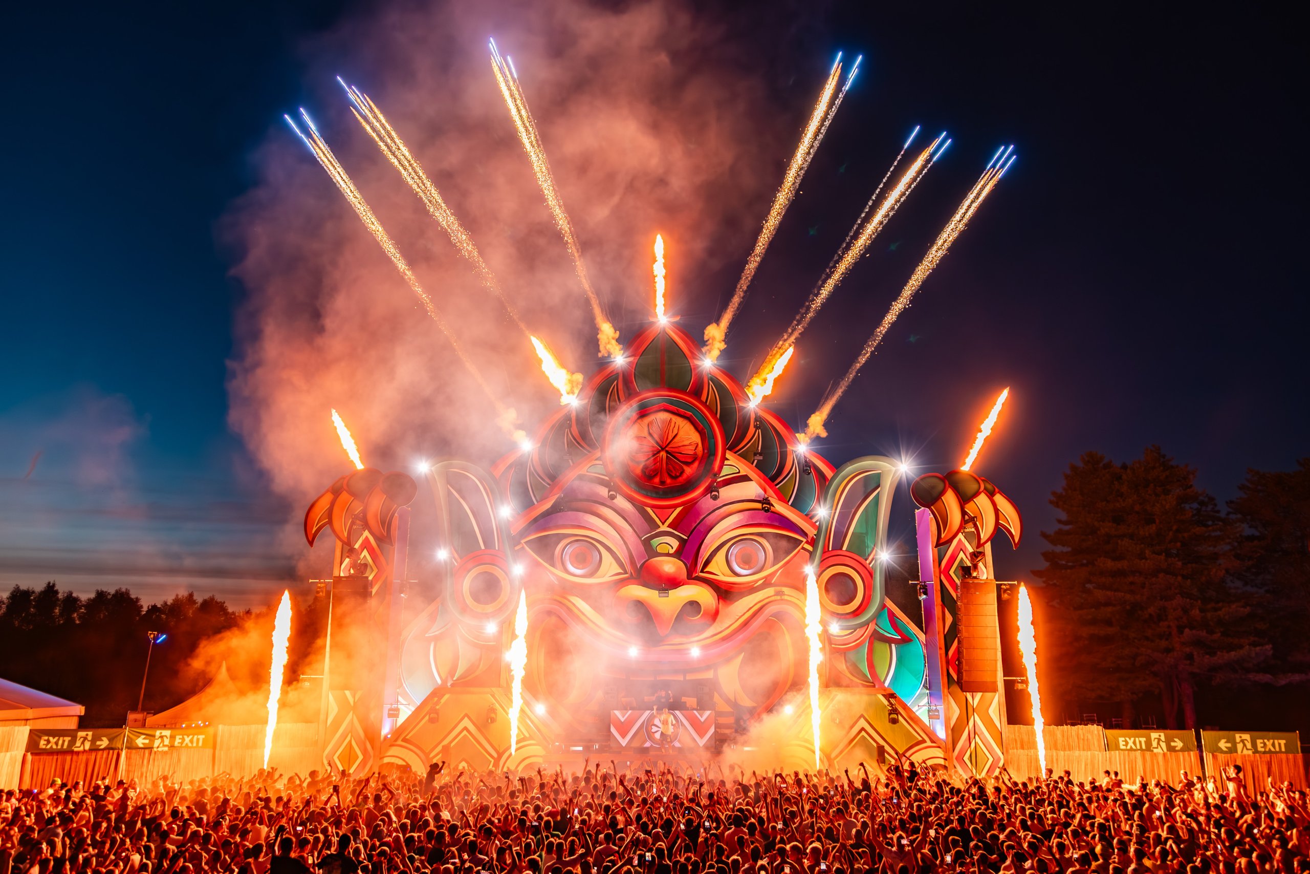 Fireworks erupt above the main stage at Magic Island Festival 2025 while the crowd watches
