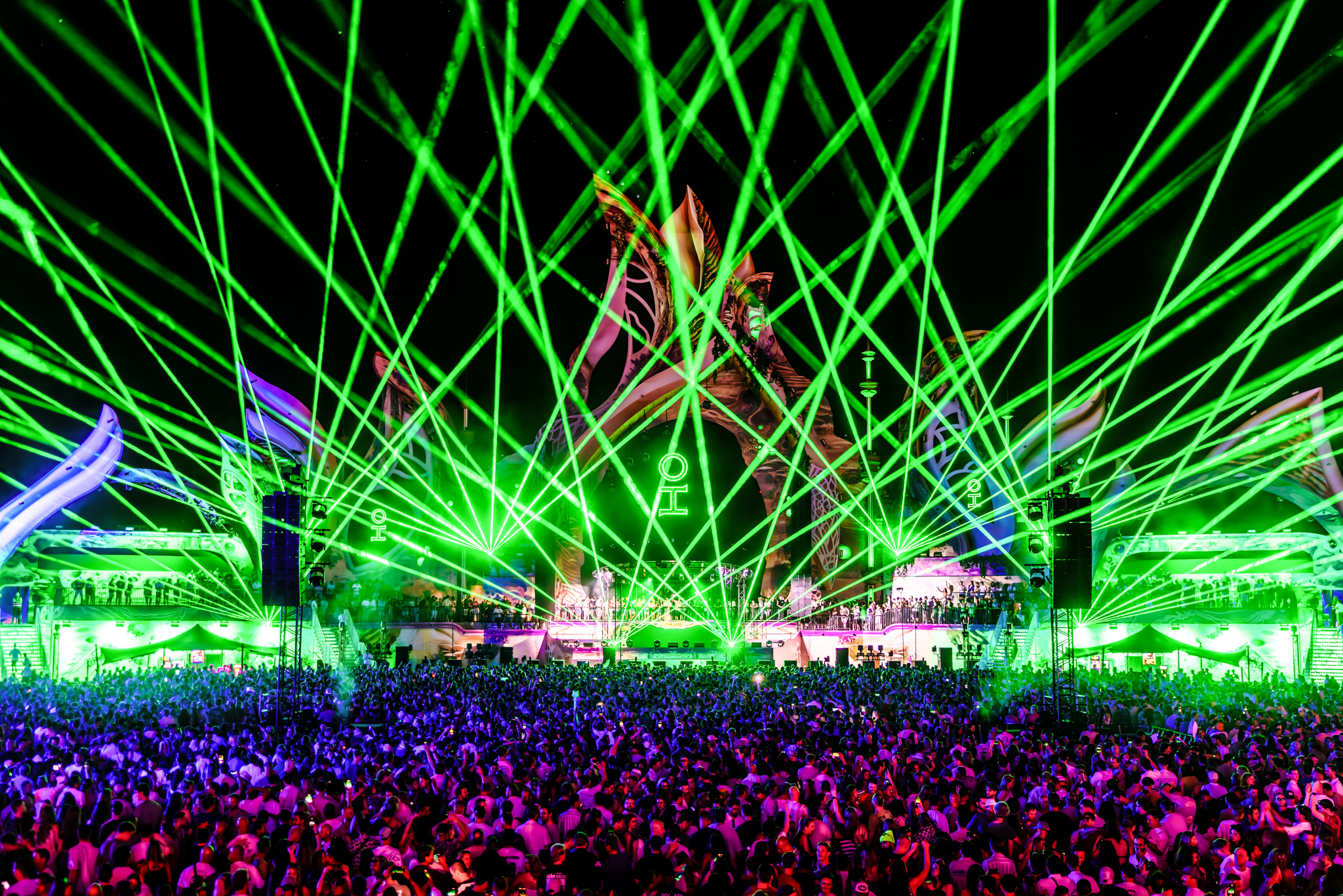 Green lasers over the crowd at night at 7th Sunday Festival 2026