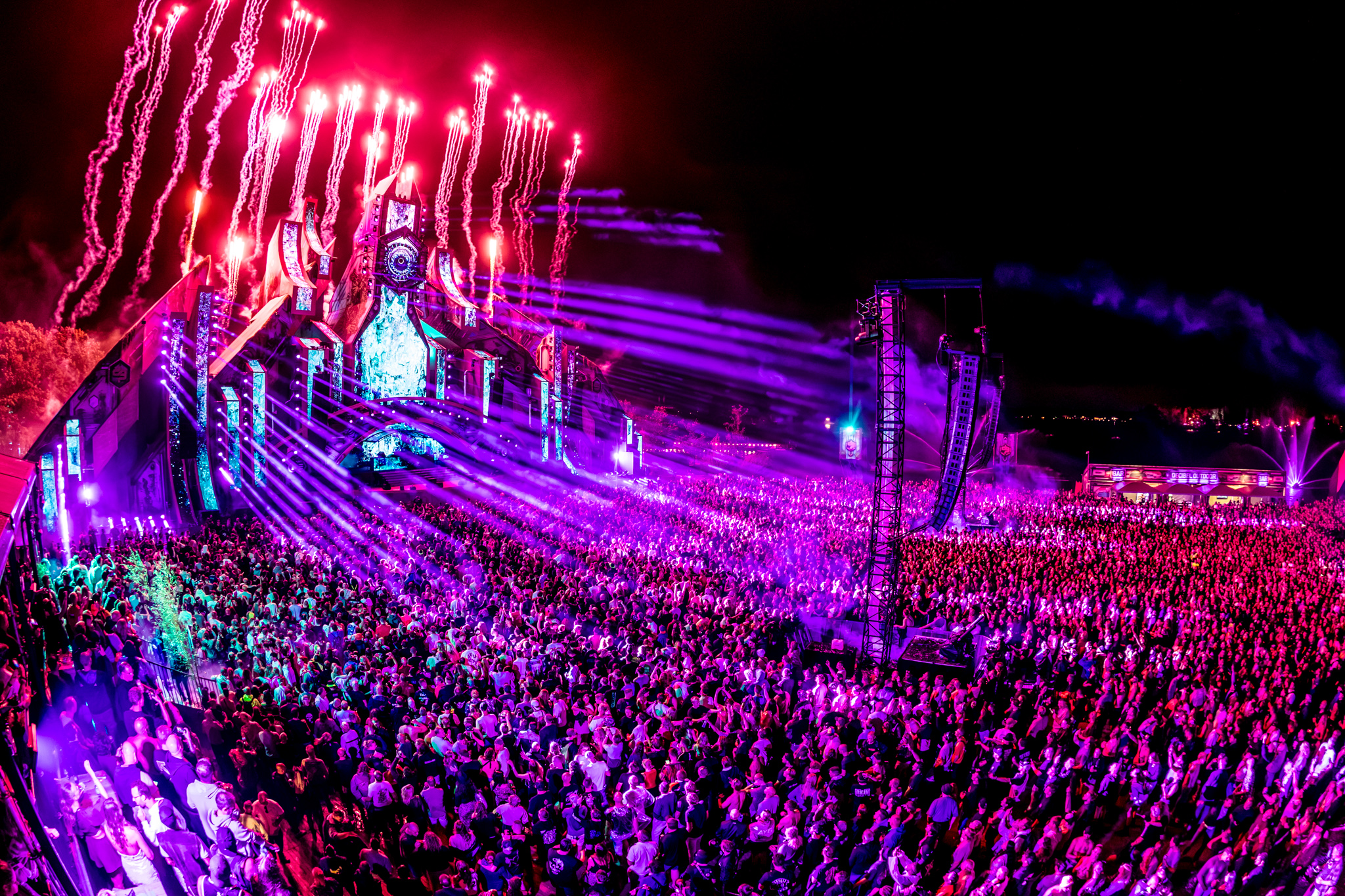 Pink pyro and lasers over the packed field at Decibel Outdoor Festival 2026