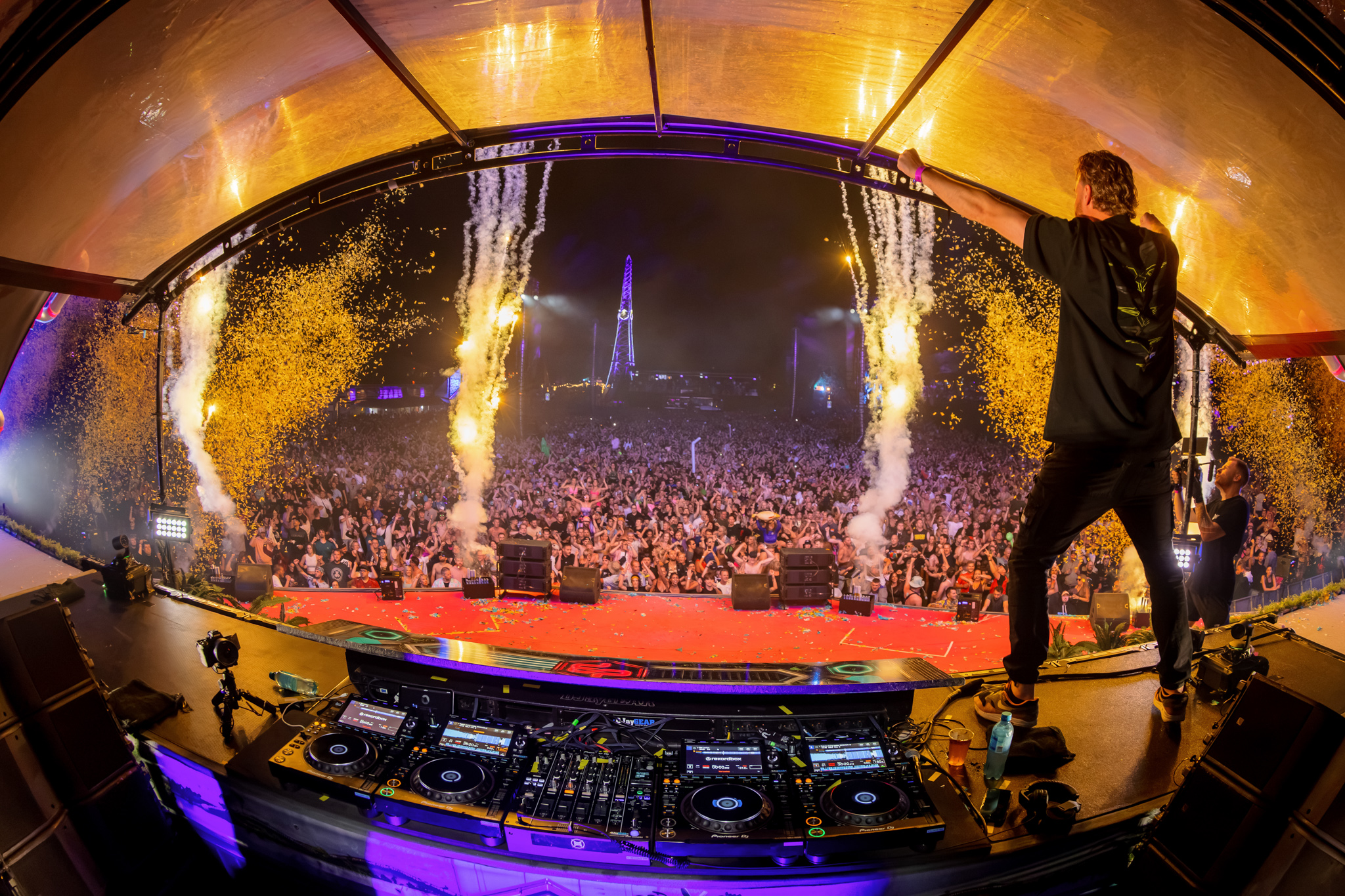 DJ in the booth with sparklers and a packed field at Decibel Outdoor Festival 2026