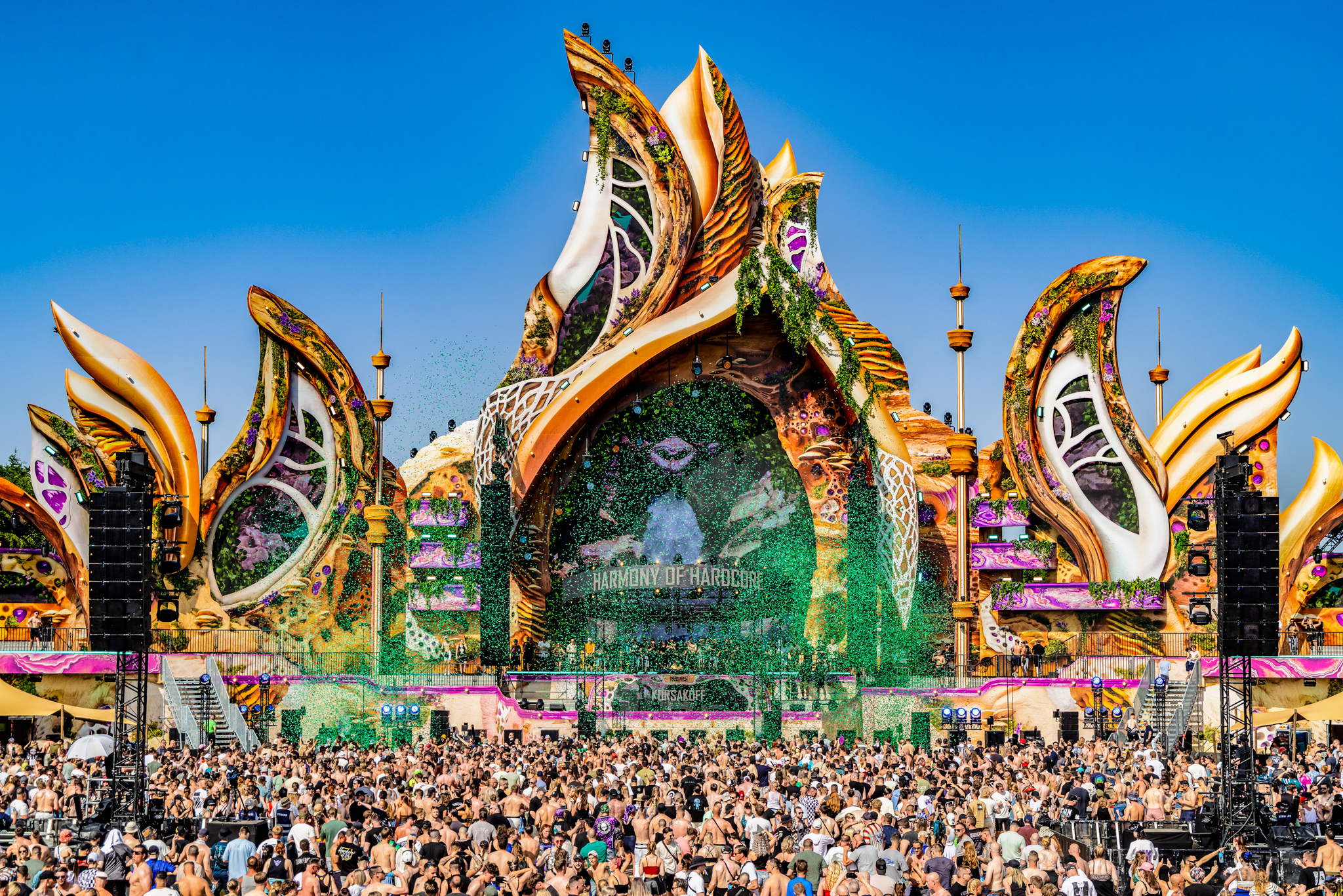 Golden mainstage in daylight with crowd at Harmony of Hardcore 2026, Erp