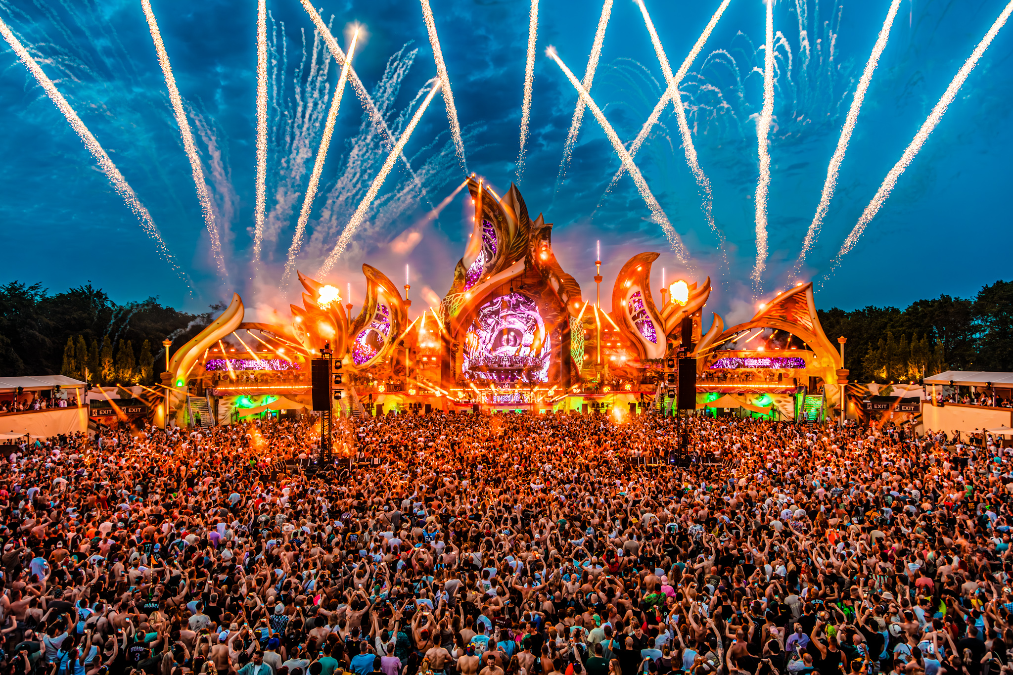 Rockets shoot up from the mainstage into the evening sky at Harmony of Hardcore 2026