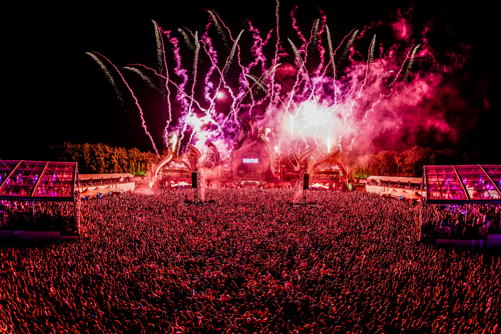 Pink fireworks over the packed festival field at Harmony of Hardcore 2026
