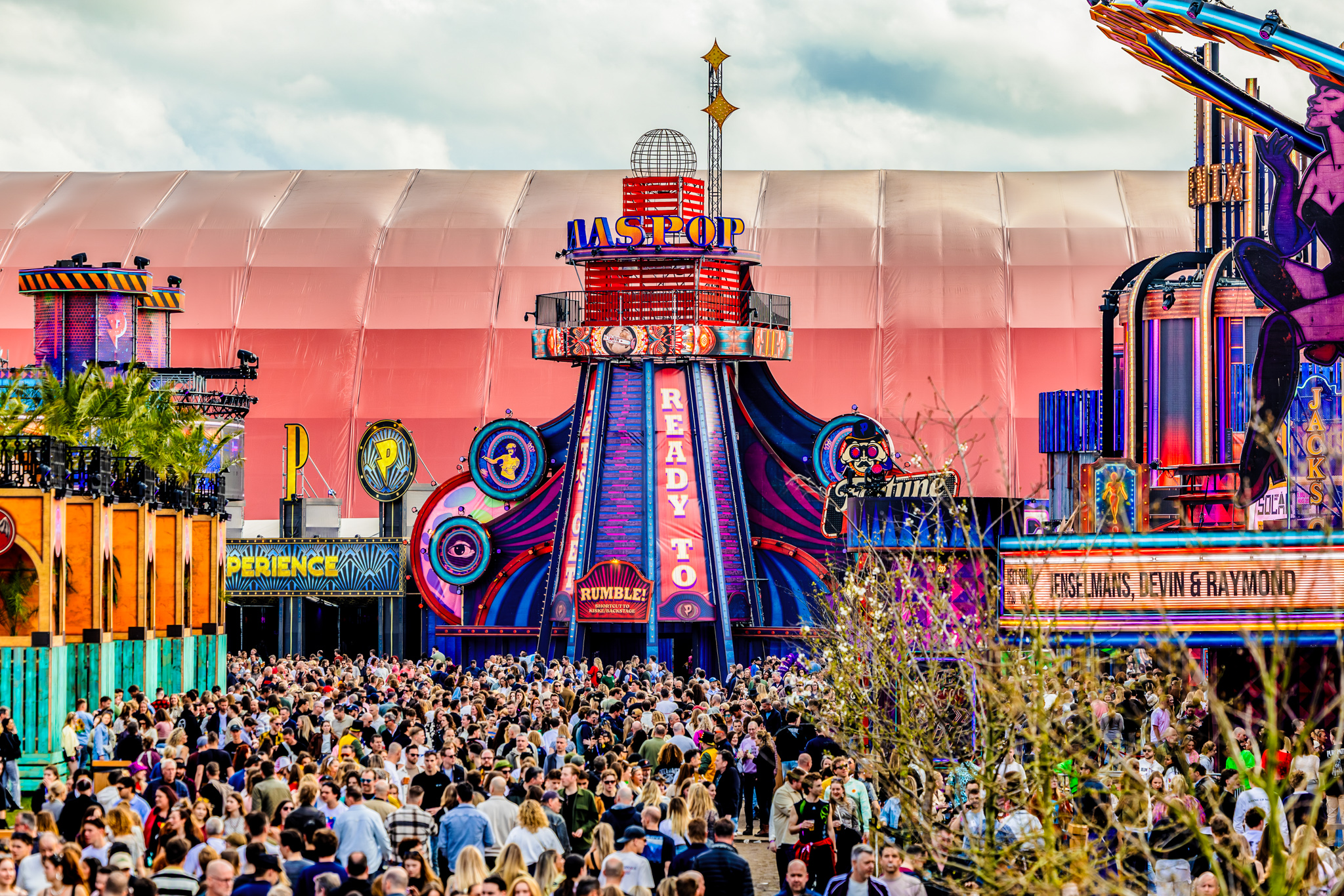 Festival crowd in front of the colourful Paaspop tower at Paaspop 2026