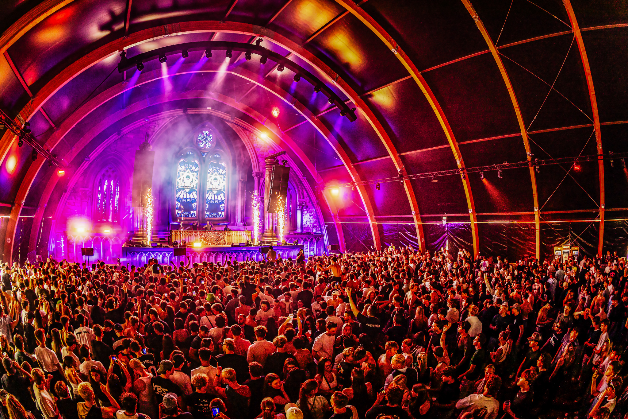 Packed arched hall with stained-glass windows at Sunset Festival 2026